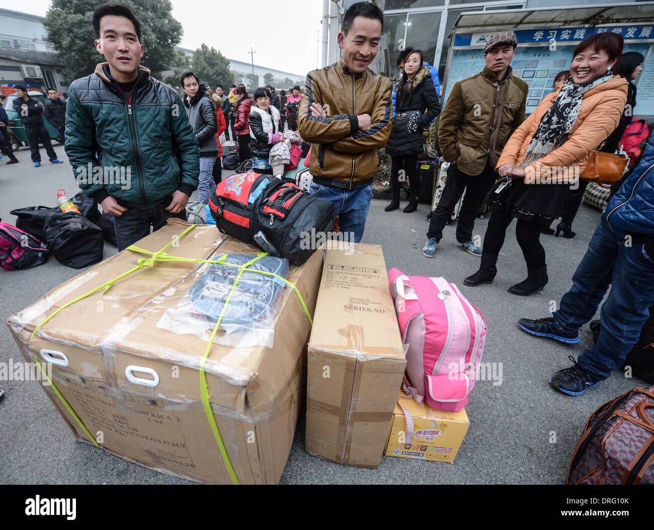 Anji, China's Zhejiang Province. 25th Jan, 2014. Workers of Henglin Chair Industry, a local private company, wait for chartered buses to return home in Anji County, east China's Zhejiang Province, Jan. 25, 2014. Henglin chartered 20 buses to send its workers home for free for family reunion prior to the Spring Festival, which falls on Jan. 31 this year. © Xu Yu/Xinhua/Alamy Live News Stock Photo
