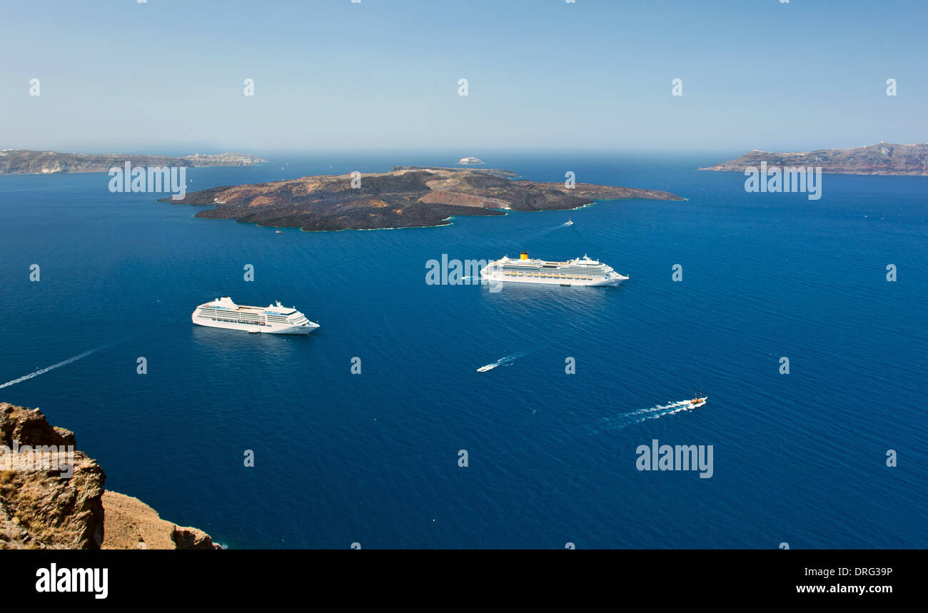 cruise ship near volcano on island of Santorini, Greece. Stock Photo