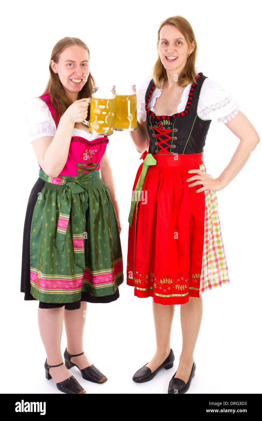 Beautiful women in dirndl drinking double beer at bavarian feast Stock Photo