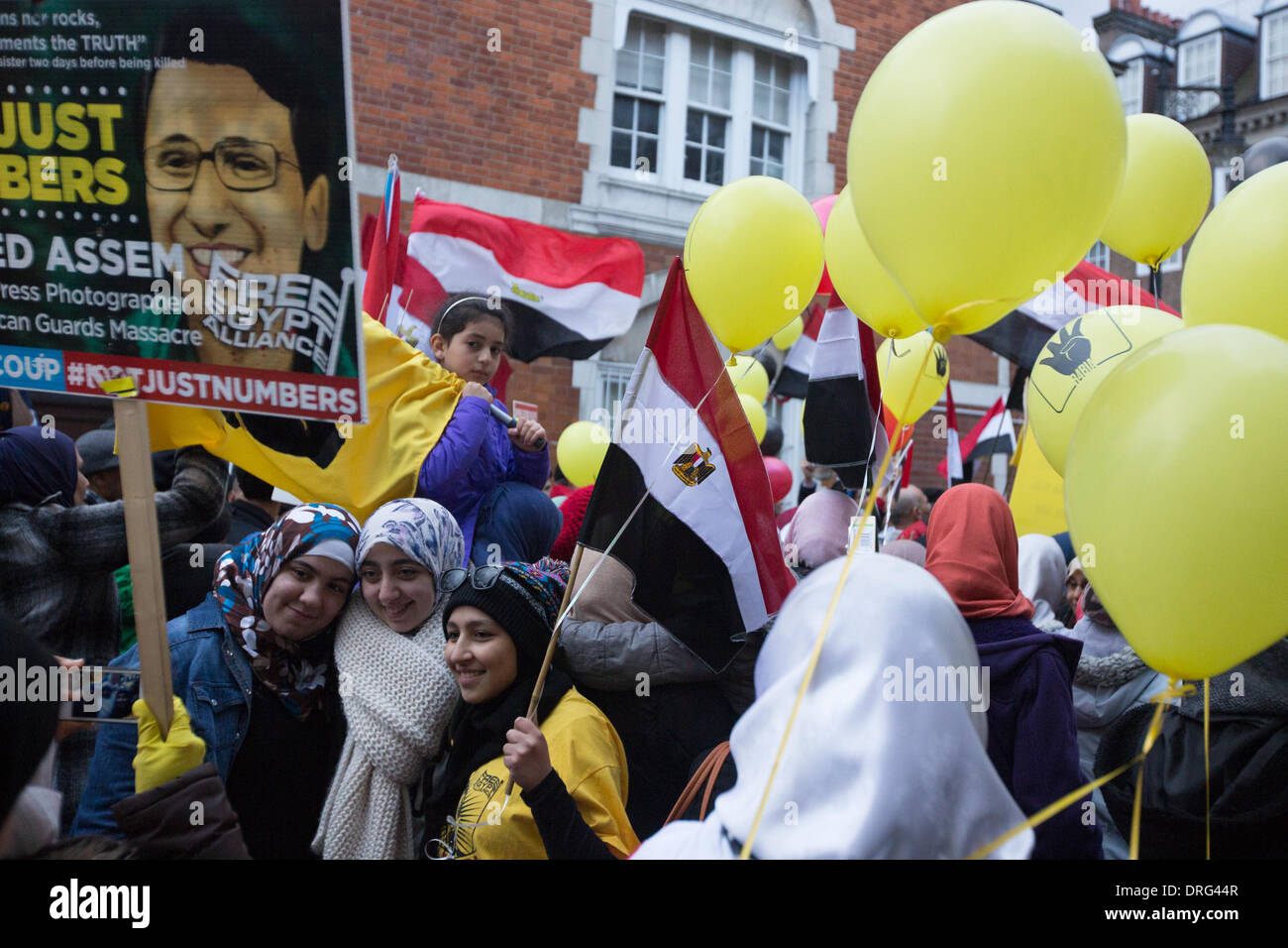 London, UK. 25th January 2014.  Protesters chant pro Morsi slogans and dance in front of the Egyptian Embassy in London. Credit:  Lydia Pagoni/Alamy Live News Stock Photo