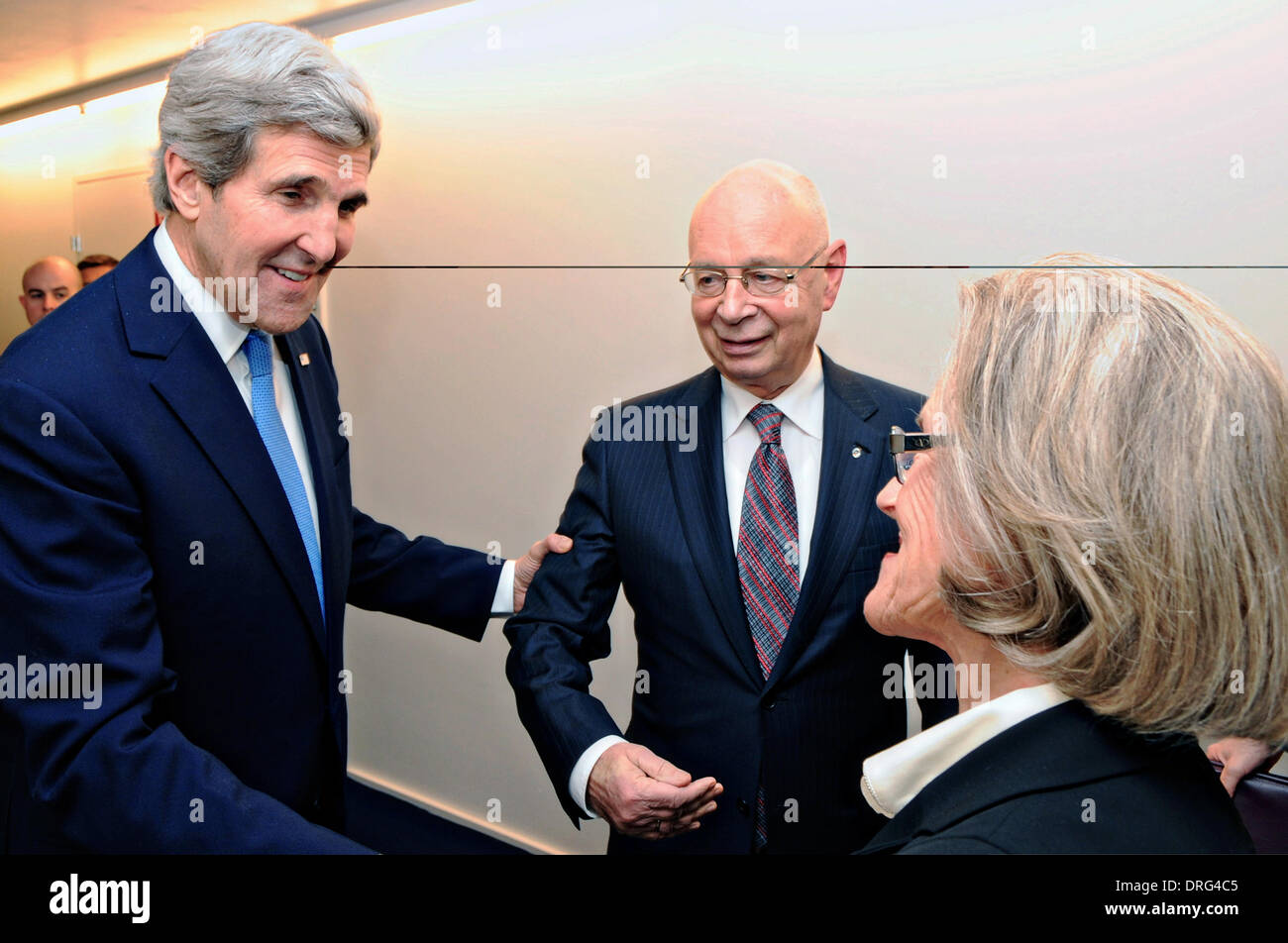 US Secretary of State John Kerry is greeted by Klaus and Hilde Schaub, the co-hosts of the World Economic Forum, before delivering the keynote address at the annual gathering January 24, 2014 in Davos, Switzerland. Stock Photo