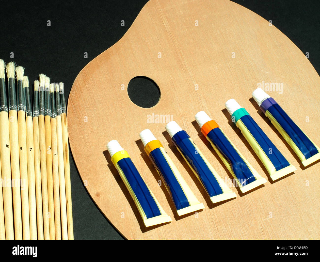 An image showing an artists equipment, Paint palette, brushes and paints Stock Photo