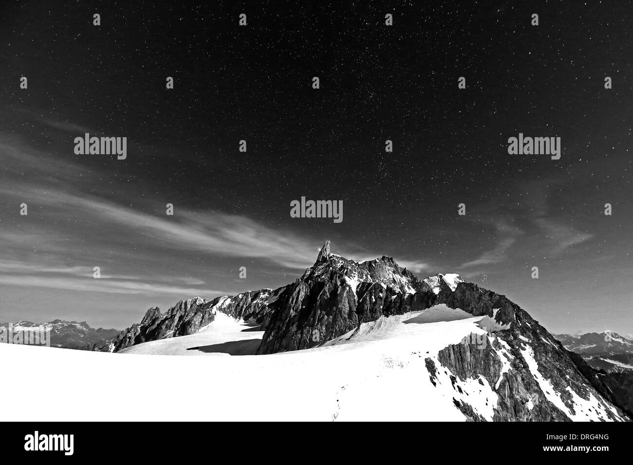 Moonlight on the Dent du Géant mountain peak.The Mont Blanc massif (Monte Bianco). Black white mountain night landscape, starry sky. Alps. Stock Photo