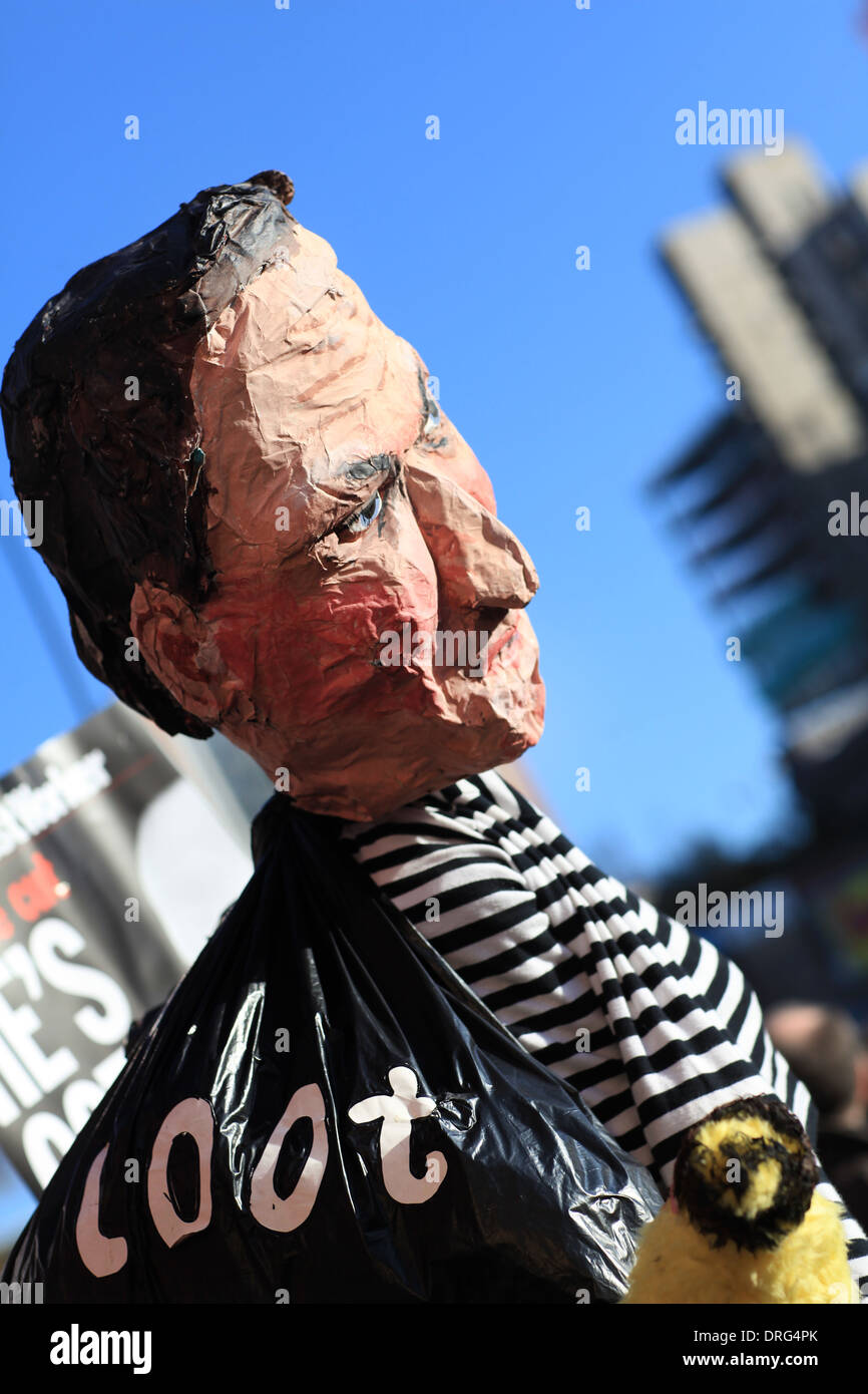 A paper mache puppet of British Prime Minister David Cameron holding a bag of loot ( money) Stock Photo