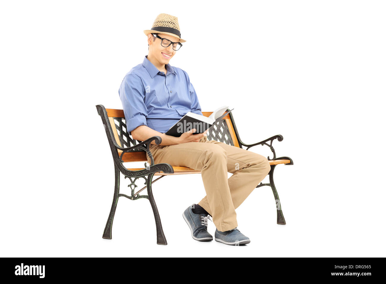 Young man with glasses reading a book on wooden bench Stock Photo