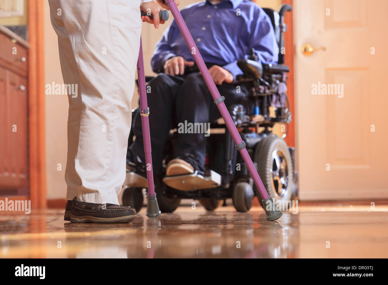 Woman with Cerebral Palsy using crutches and her husband with Cerebral