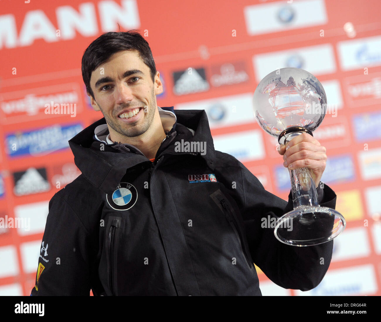 Koenigssee, Germany. 25th Jan, 2014. US American skeleton pilot Matthew Antoine holds his trophy after the race during the Skeleton World Cup in Koenigssee, Germany, 25 January 2014. Antoine was third placed. Photo: Tobias Hase/dpa/Alamy Live News Stock Photo