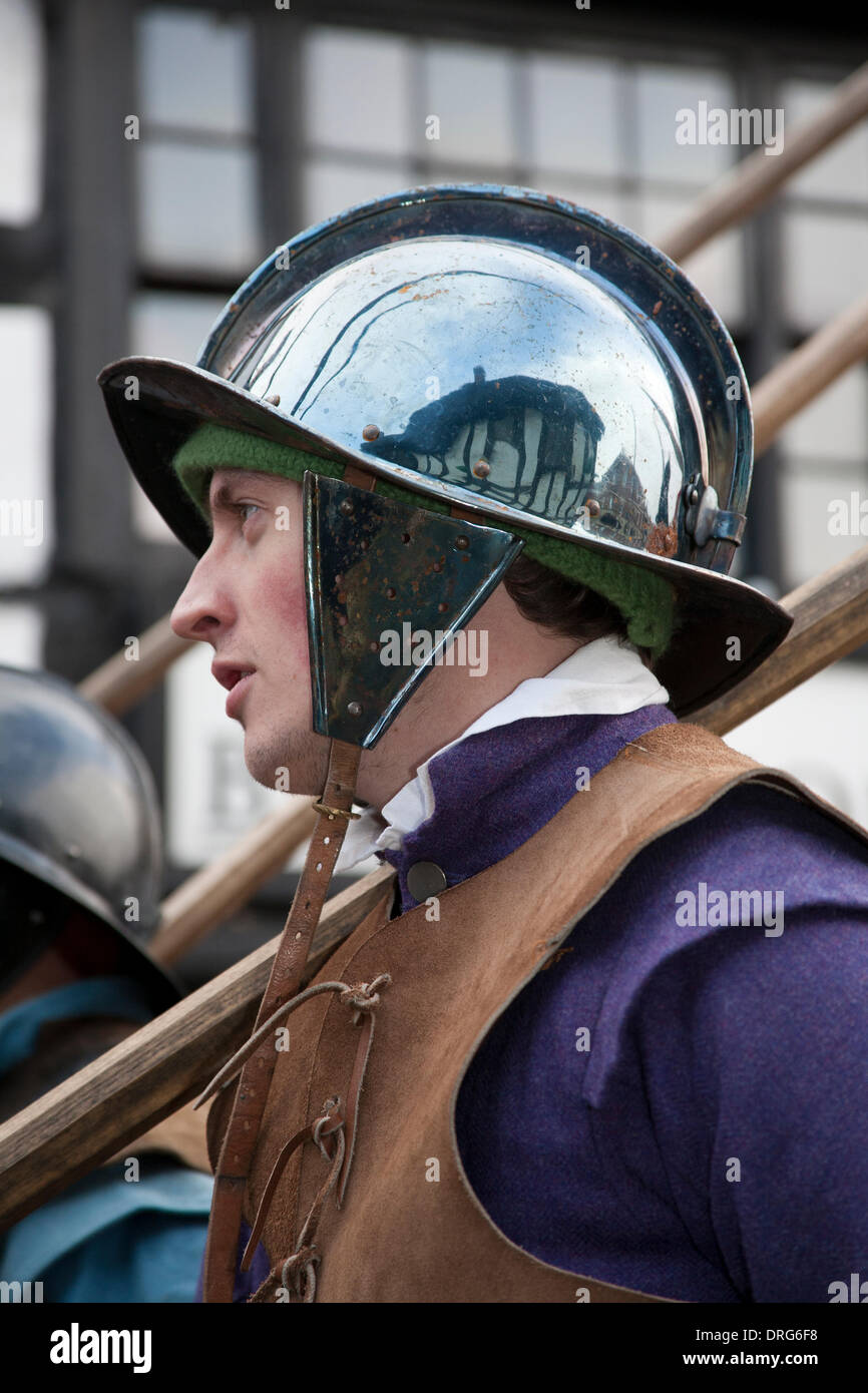 Nantwich, Cheshire, UK 25th January, 2014. Holly Holy Day & Siege of Nantwich re-enactment. For over 40 years the faithful troops of The Sealed Knot have gathered in the historic town for a spectacular re-enactment of the bloody battle that took place almost 400 years ago and marked the end of the long and painful siege of the town. Roundheads, cavaliers, and other historic entertainers converged upon the town centre to re-enact the Battle. The siege in January 1644 was one of the key conflicts of the English Civil War. Credit:  Conrad Elias/Alamy Live News Stock Photo