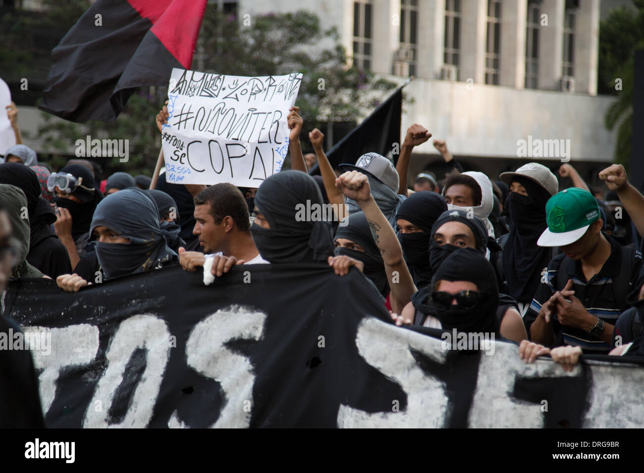 Sao Paulo, Brazil. 25th Jan, 2014. Protesters carry signs and shout slogans during a rally at Paulista Avenue in Sao Paulo against the World Cup in Brazil. People took to the street to complain about the costs of staging the World Cup in Brazil.  Credit:  Andre M. Chang/Alamy Live News Stock Photo
