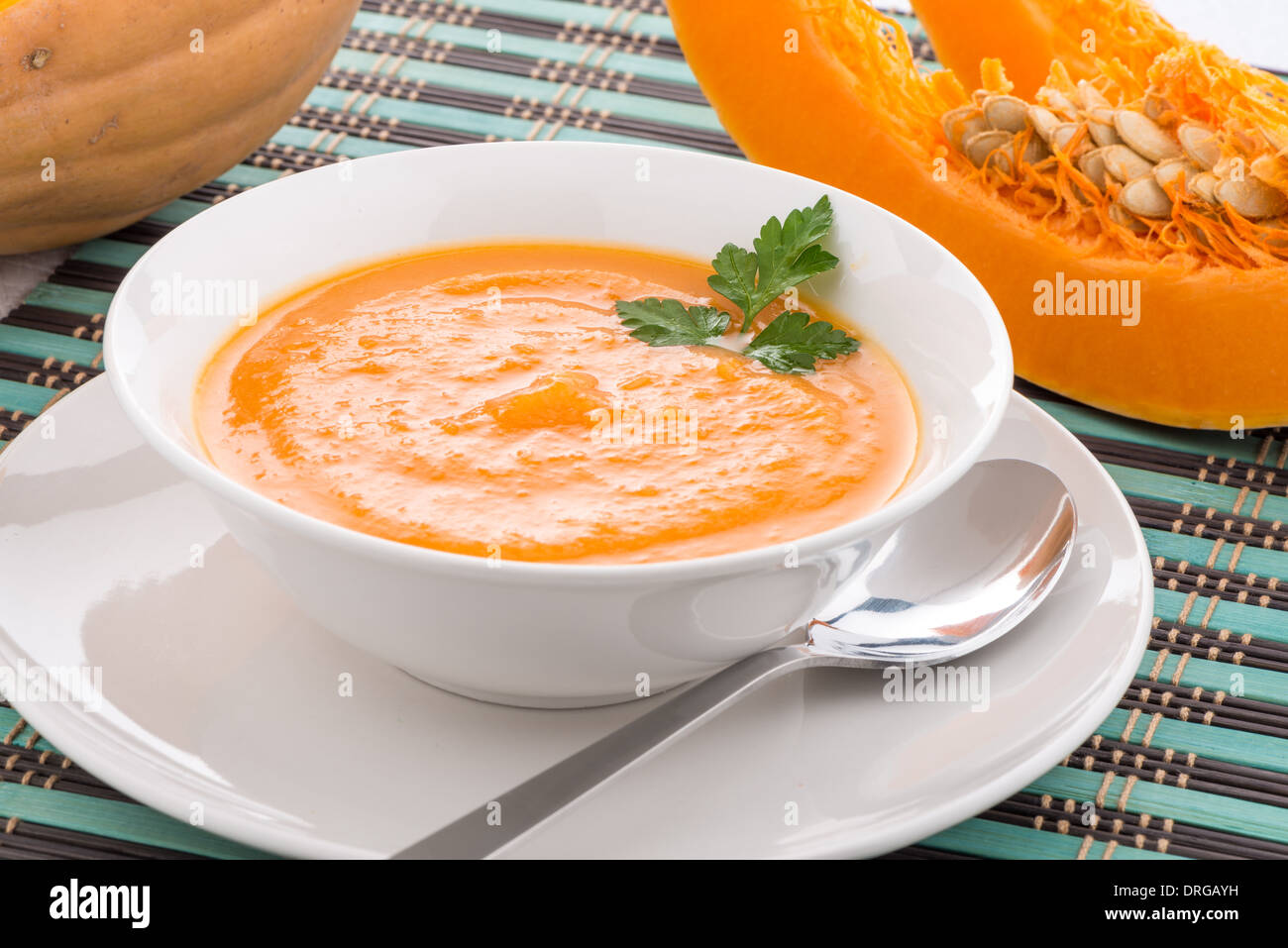 Pumpkin soup on white wood background Stock Photo - Alamy