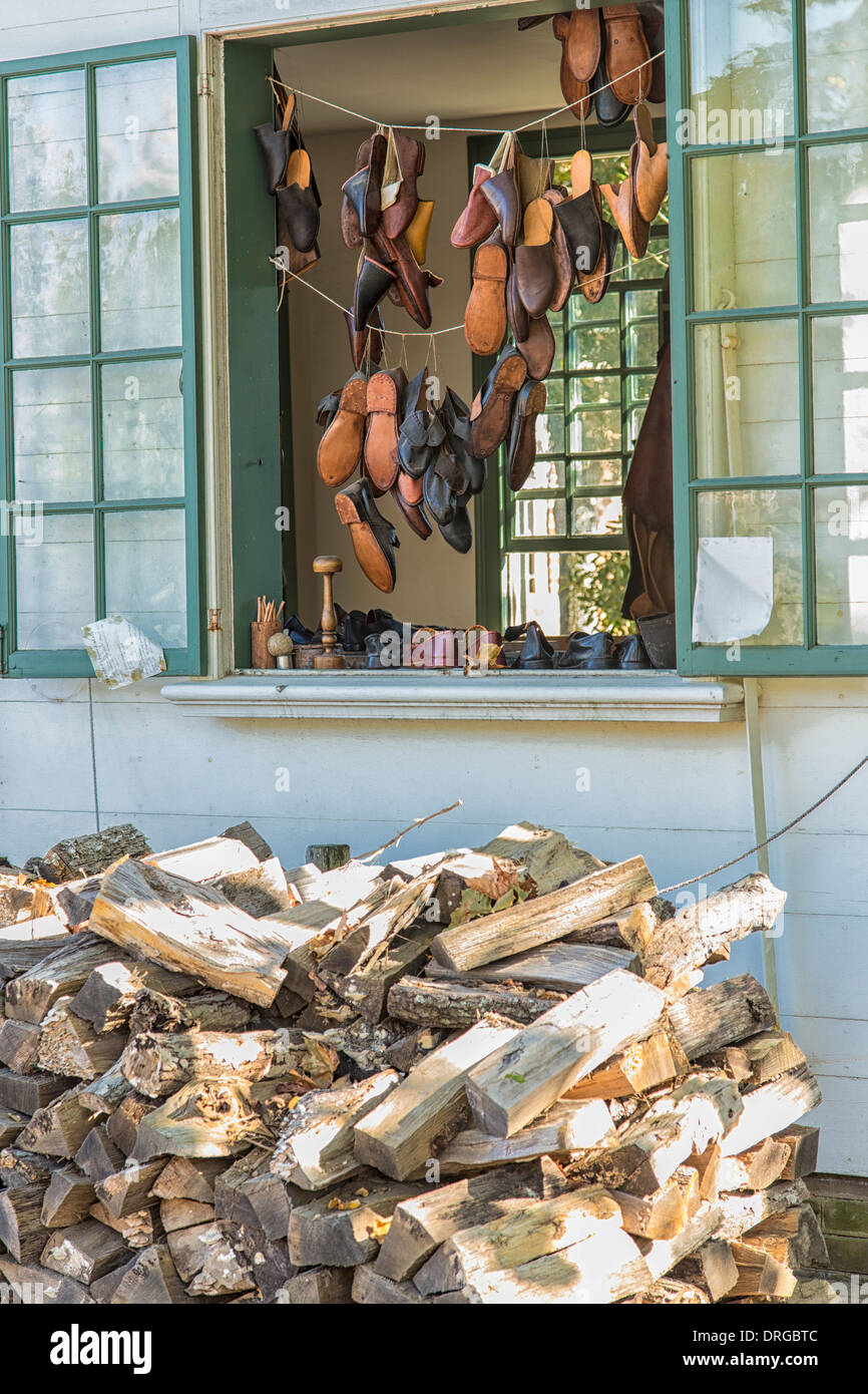 Colonial Williamsburg window display at the shoemaker's shop with firewood supply for cool weather Stock Photo