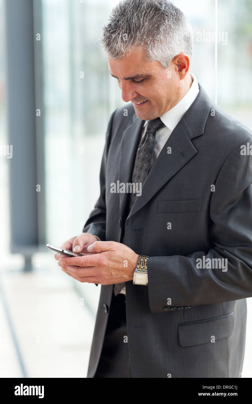 senior businessman texting using mobile phone Stock Photo