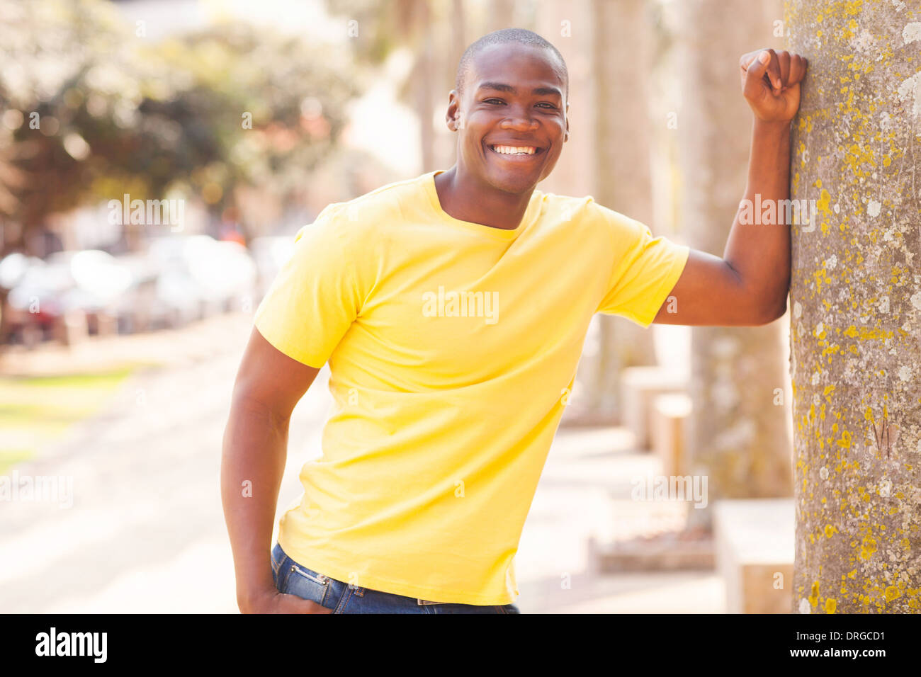 happy young African man wearing casual clothes in urban city Stock Photo
