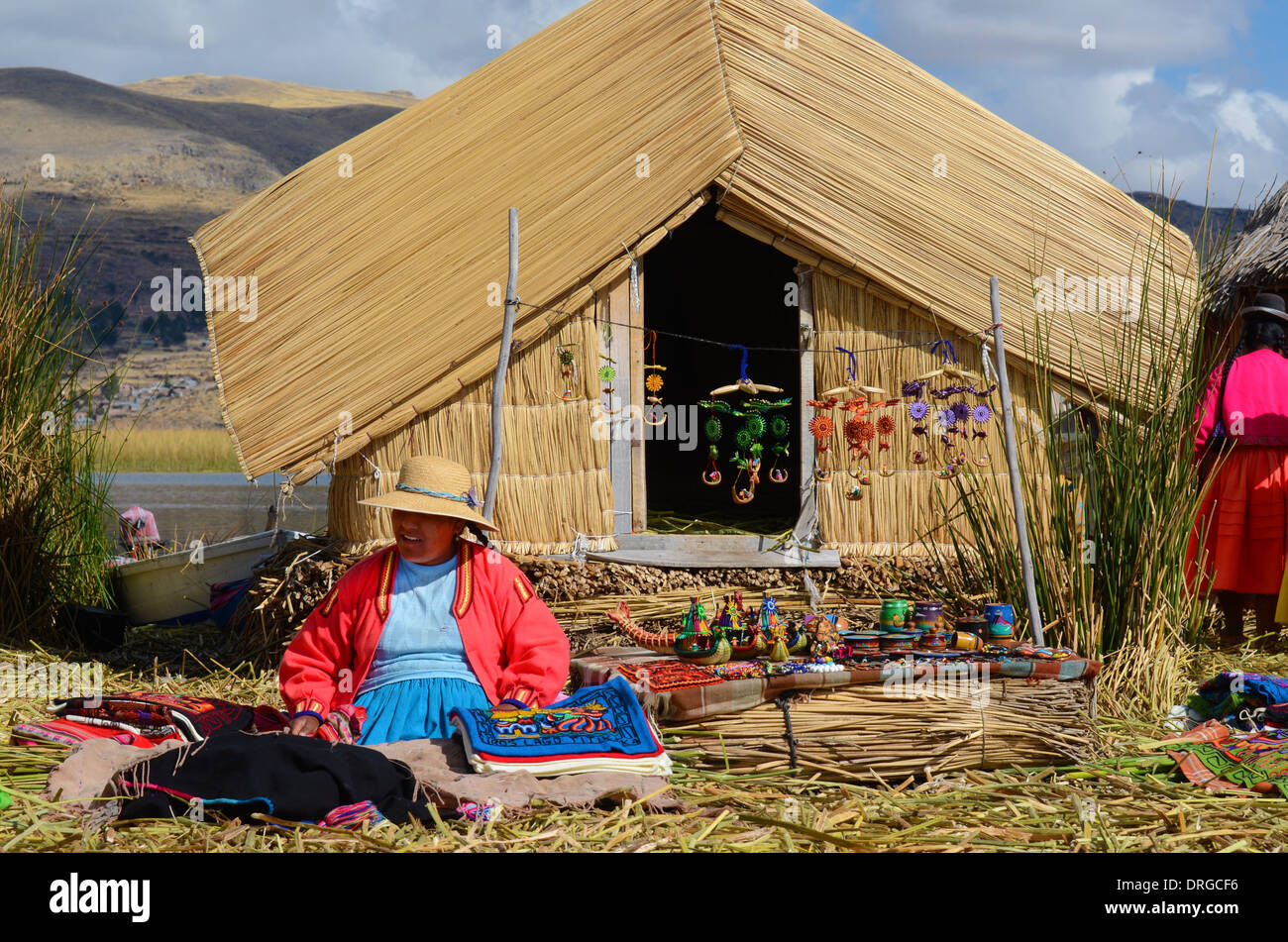 LAKE TITICACA, PERU - AUGUST 3: Uros Indian woman peddling her wares on a reed island in Lake Titicaca August 3, 2013. Stock Photo