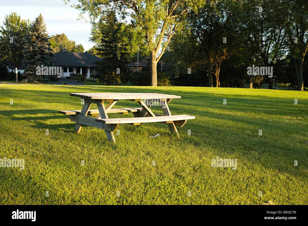 Picnic wooden table and bench at sunset in country park. A Frame garden table and bench Stock