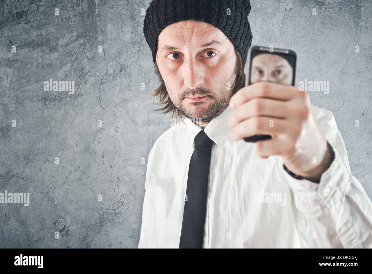 Businessman taking self or selfie portrait with mobile phone Stock Photo