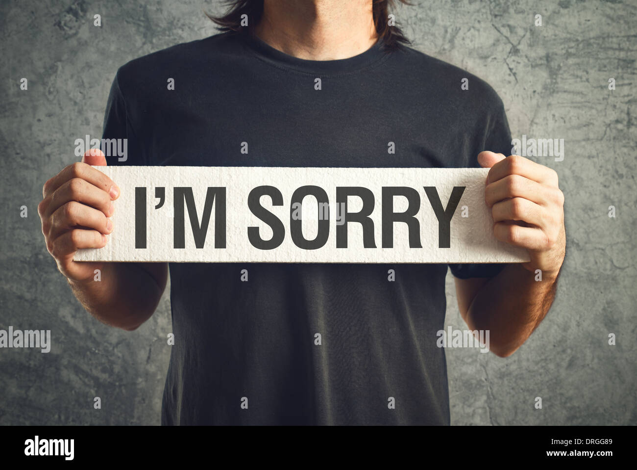 Man holding I am sorry message on white board. remorse concept. Stock Photo