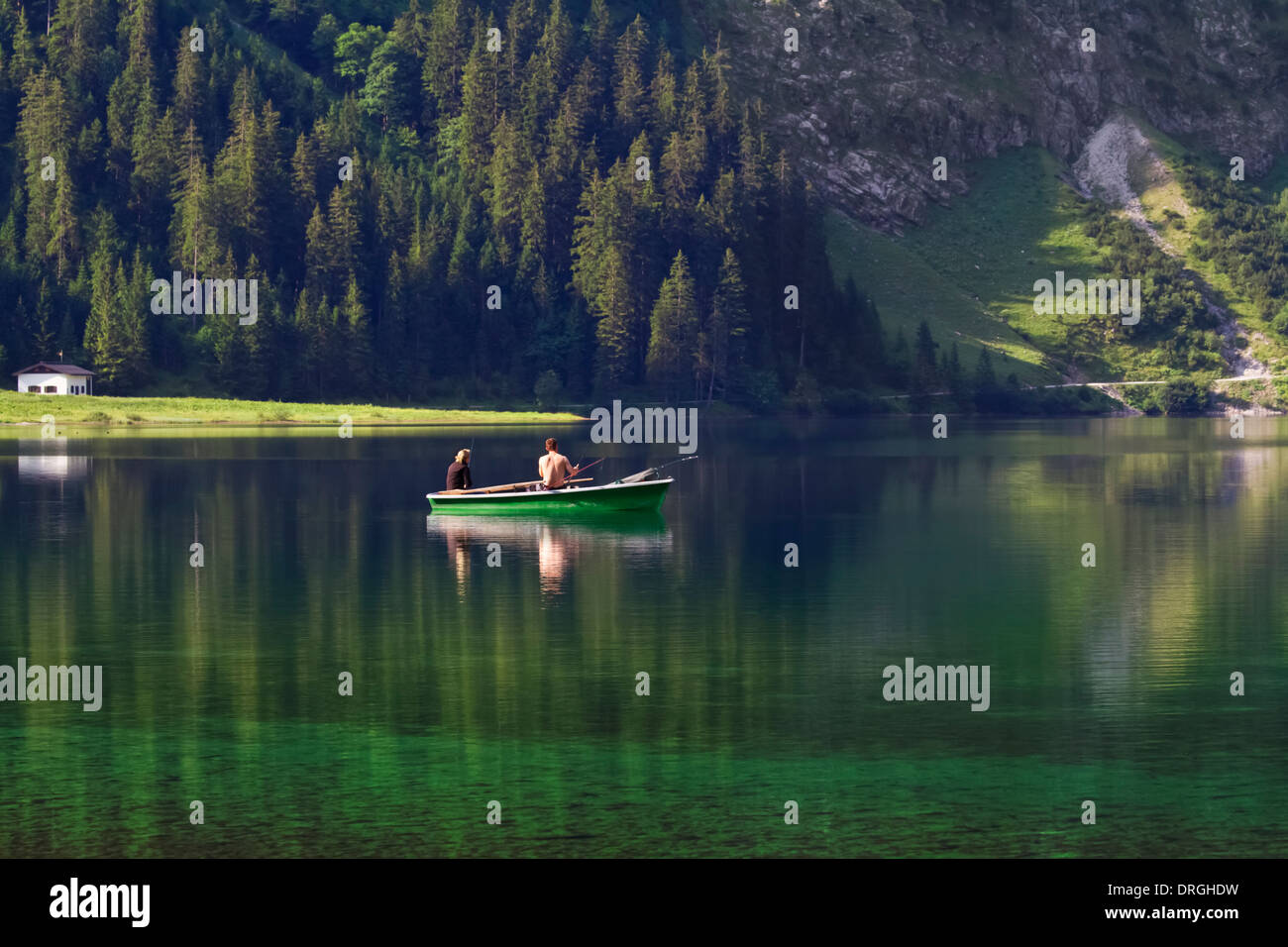 Young couple is fishing in the lake Stock Photo