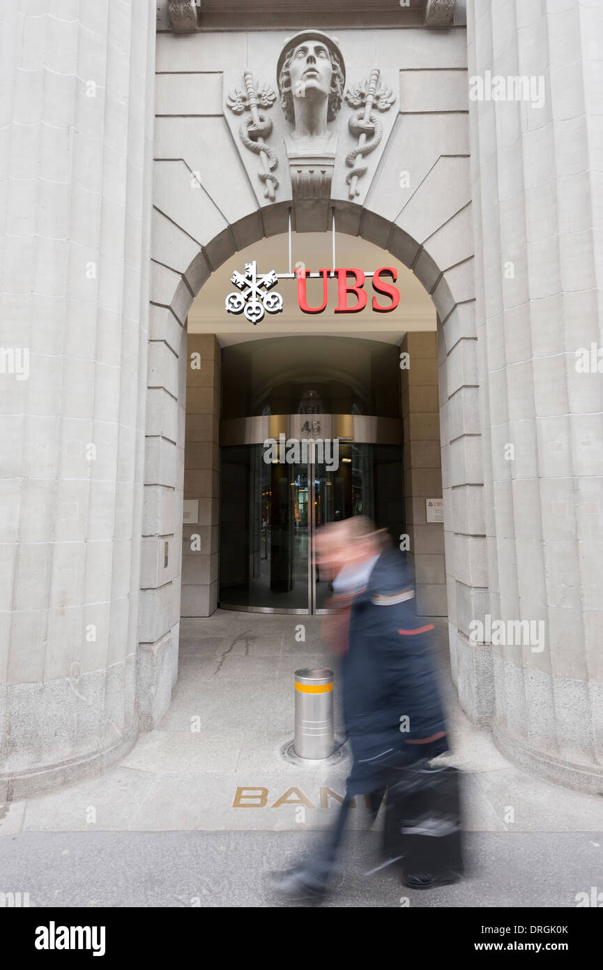 A man is passing by the entrance door of UBS bank's head office on Bahnhofstrasse in Zurich, Switzerland, downtown. Stock Photo