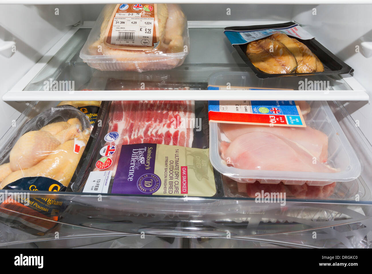 Fresh meat and poultry kept inside a fridge Stock Photo