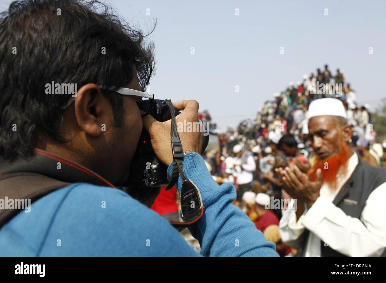 A photographer take picture of Muslim devotees attend the Akheri Munajat. Dhaka,Bangladeshi Muslim devotees attend the Akheri Munajat concluding prayers on the third day of Biswa Ijtema, the second largest Muslim congregation after the Hajj, at Tongi with more than two million Muslims from Bangladesh and abroad. The Biswa Ijtema, the world’s second largest religious gathering of Muslims concluded with the prayer of Akheri Munajat on the bank of river Turag. The event focuses on prayers and meditation and does not allow political discussion. Stock Photo