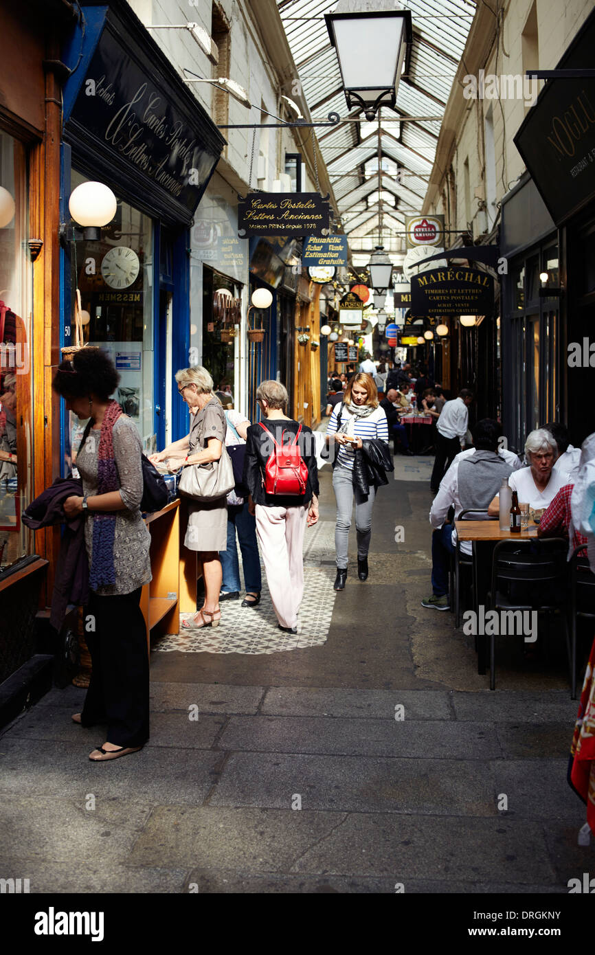 Shoppers and diners in arcade in Paris Stock Photo