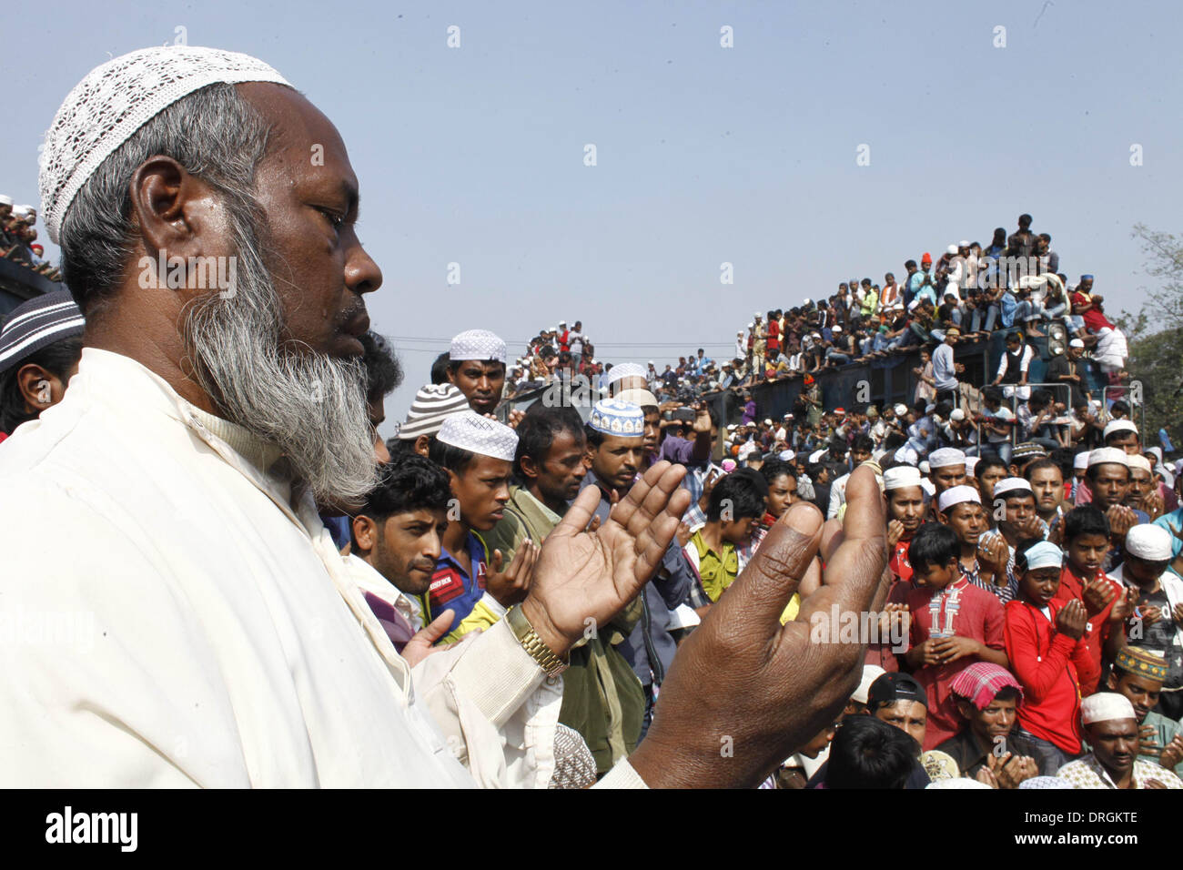 Dhaka,Bangladesh. 26th Jan, 2014. Bangladeshi Muslim devotees attend the Akheri Munajat concluding prayers on the third day of Biswa Ijtema, the second largest Muslim congregation after the Hajj, at Tongi with more than two million Muslims from Bangladesh and abroad. The Biswa Ijtema, the world’s second largest religious gathering of Muslims concluded with the prayer of Akheri Munajat on the bank of river Turag. The event focuses on prayers and meditation and does not allow political discussion.  Thousands of Muslims joined the prayer at the Biswa Ijtema grounds and surrounding areas. Stock Photo
