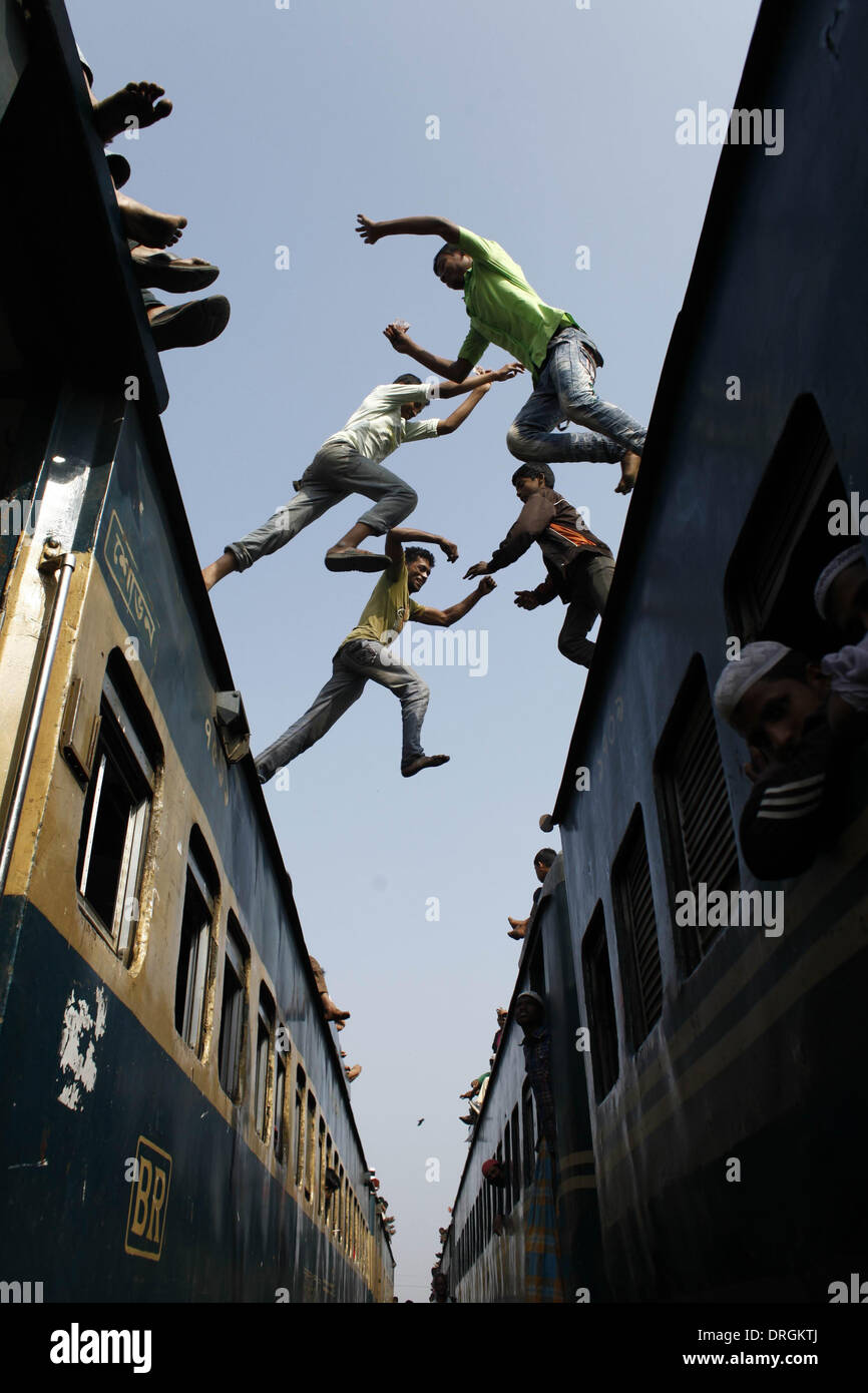 Dhaka,Bangladesh. 26th Jan, 2014. Men jump between trains as Bangladeshi Muslim devotees attend the third day of Biswa Ijtema, the second largest Muslim congregation after the Hajj, at Tongi Railway station in Tongi. More than two million Muslims from Bangladesh & abroad. The Biswa Ijtema, the world’s second largest religious gathering of Muslims concluded with the prayer of Akheri Munajat on the bank of river Turag. The event focuses on prayers and meditation and does not allow political discussion.  Thousands of Muslims joined the prayer at the Biswa Ijtema grounds and surrounding areas. Stock Photo