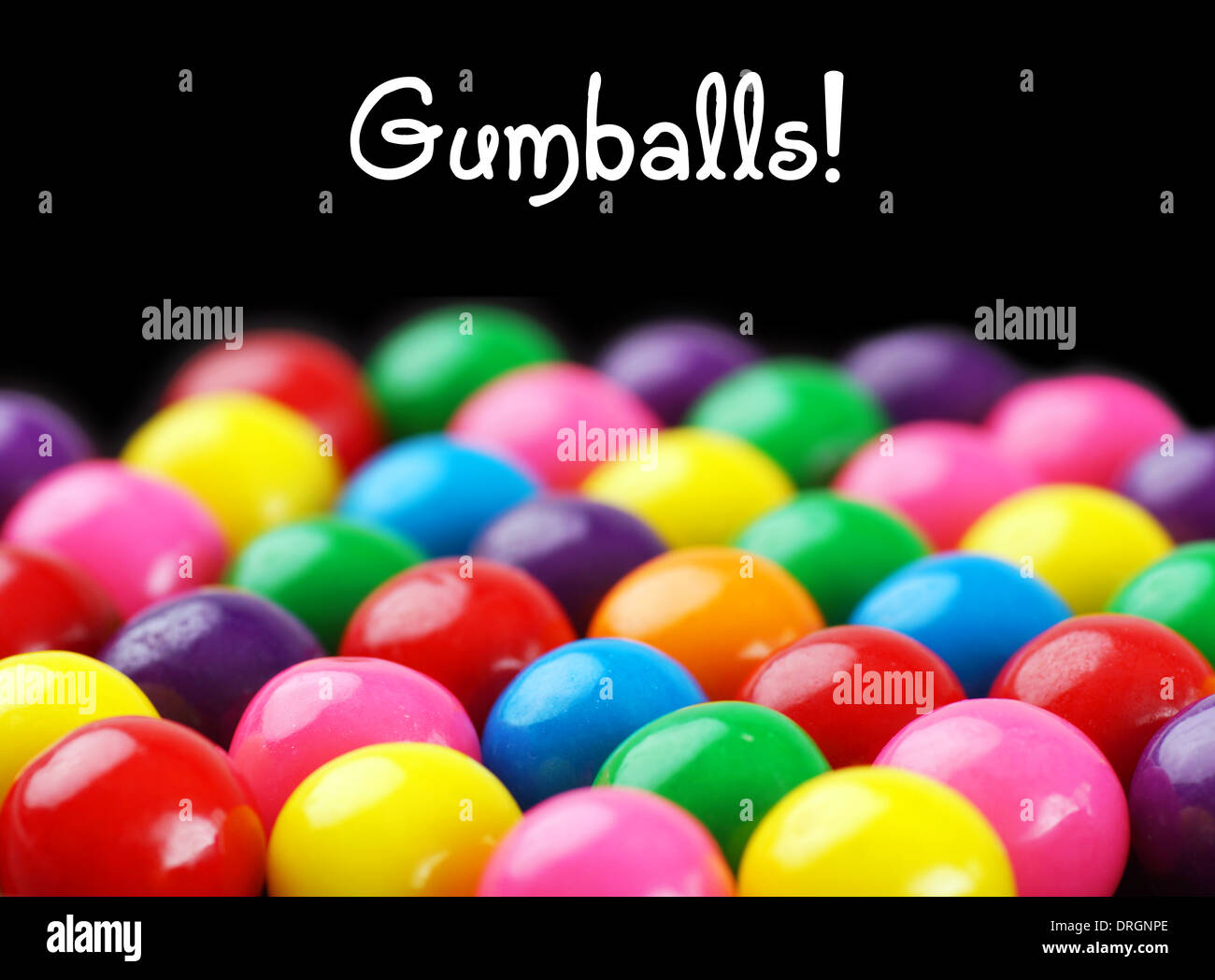 Fun and colorful gumballs on black background with text Stock Photo
