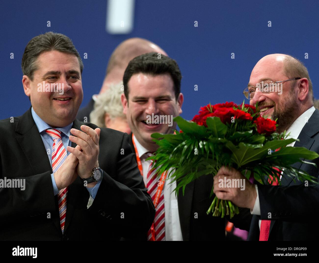 Berlin, Germany. 26th Jan, 2014. The newly elected SPD frontrunner and president of the European Parliament, Martin Schulz (SPD, C), accepts the congratulations of the chairman of the SPD, Sigmar Gabriel (L) and the vice party whip Hubertus Heil (C) during a meeting of the SPD's party executive committee in Berlin, Germany, 26 January 2014. The meeting was concerned with the forthcoming extraordinary general party conference of the SPD and the conference of the SPD's European delegates. Photo: Soeren Stache/dpa/Alamy Live News Stock Photo