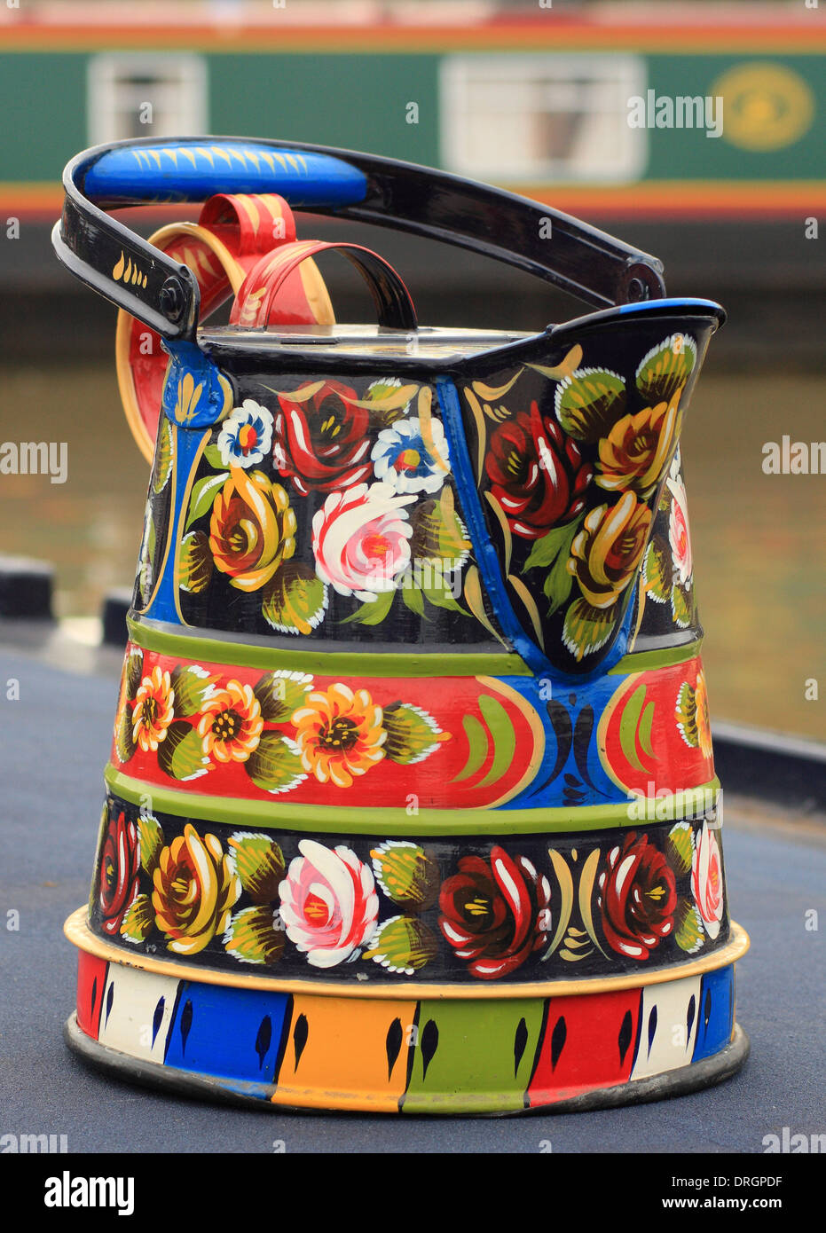 Buckby watering can decorated with traditional British 'Rose and Casttle' folk/canal art on a narrow boat, Stratford-on-Avon, UK Stock Photo