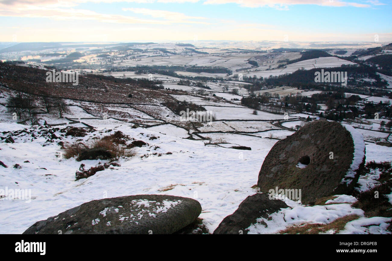 Snowfall over Curbar Edge and abandoned millstone looking across the Derwent Valley over Calver, Peak District NP, Derbyshire UK Stock Photo