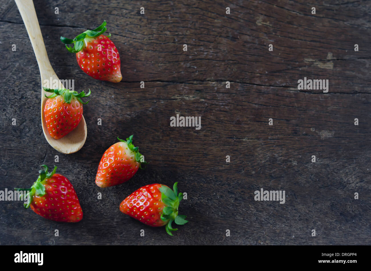 still life fresh strawberries with spoon over wooden background Stock ...