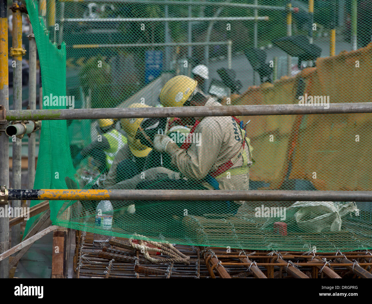 Migrant workers at a construction site by a highway in Singapore Stock ...