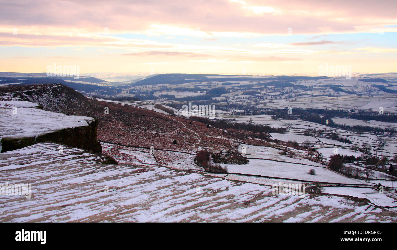 Sunset after snowfall on Curbar Edge above the Derwent Valley in the Peak District, Derbyshire, UK Stock Photo
