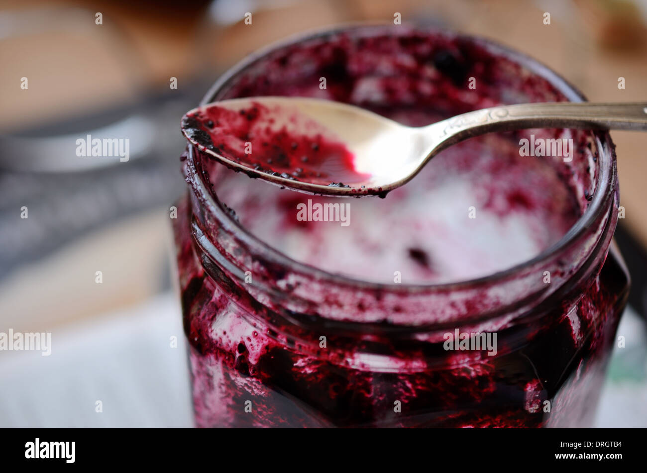 teaspoon and pot of jam on a table Stock Photo