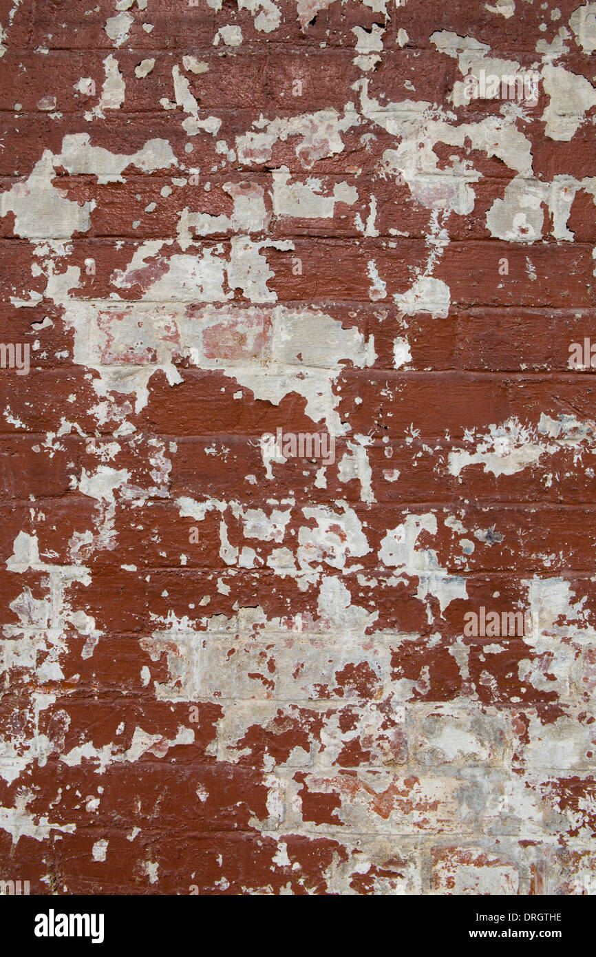 Section of brick wall covered in peeling paint Stock Photo Alamy