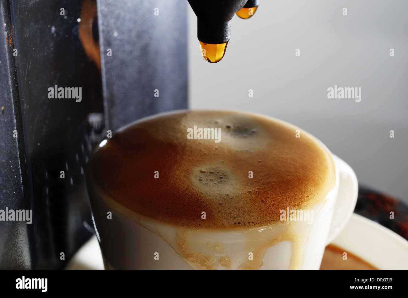 cup of espresso and coffee machine in progress Stock Photo