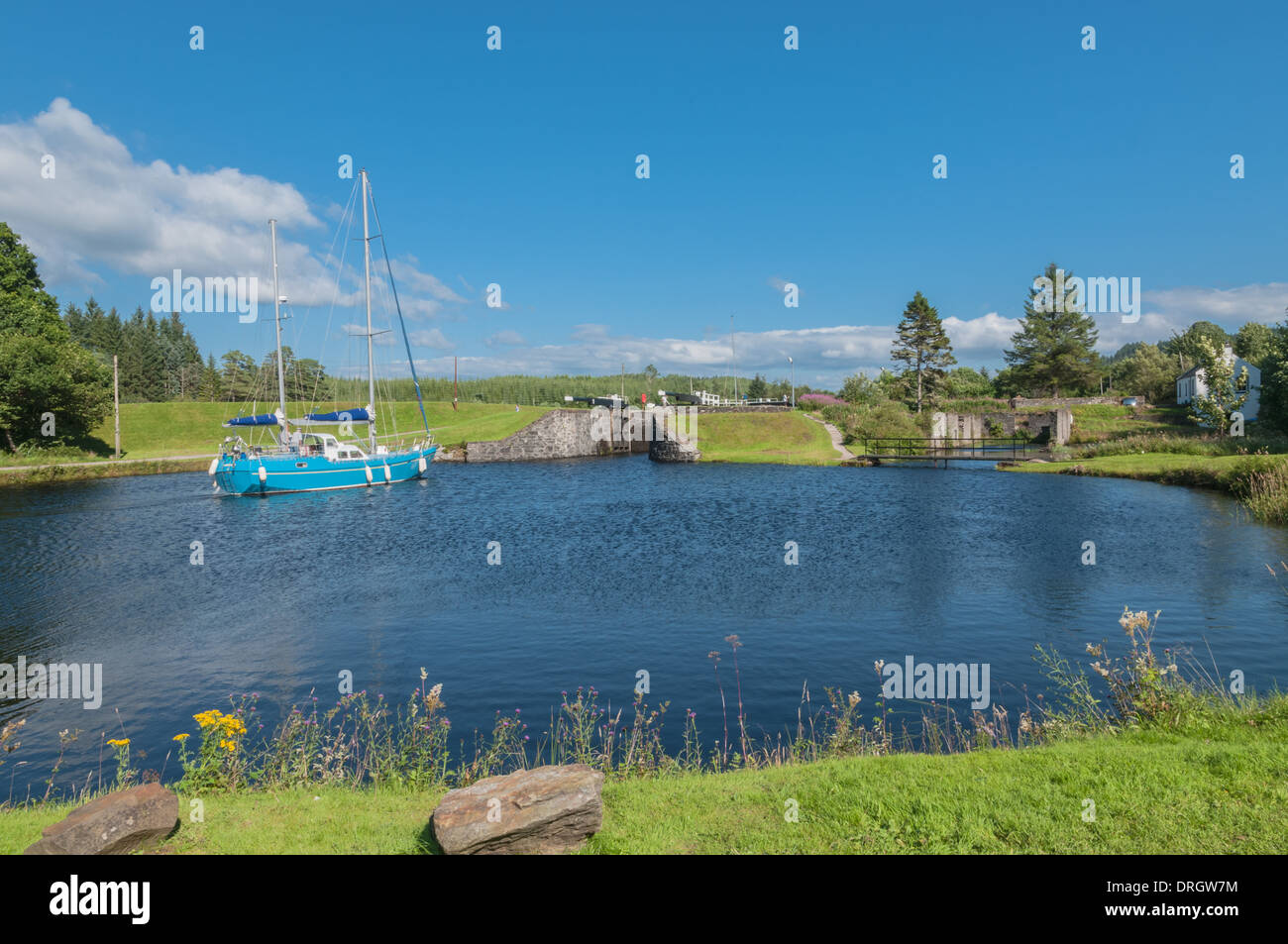 Yacht going along CrinanCanal at Dunardry Locks Argyll & Bute Scotland Stock Photo