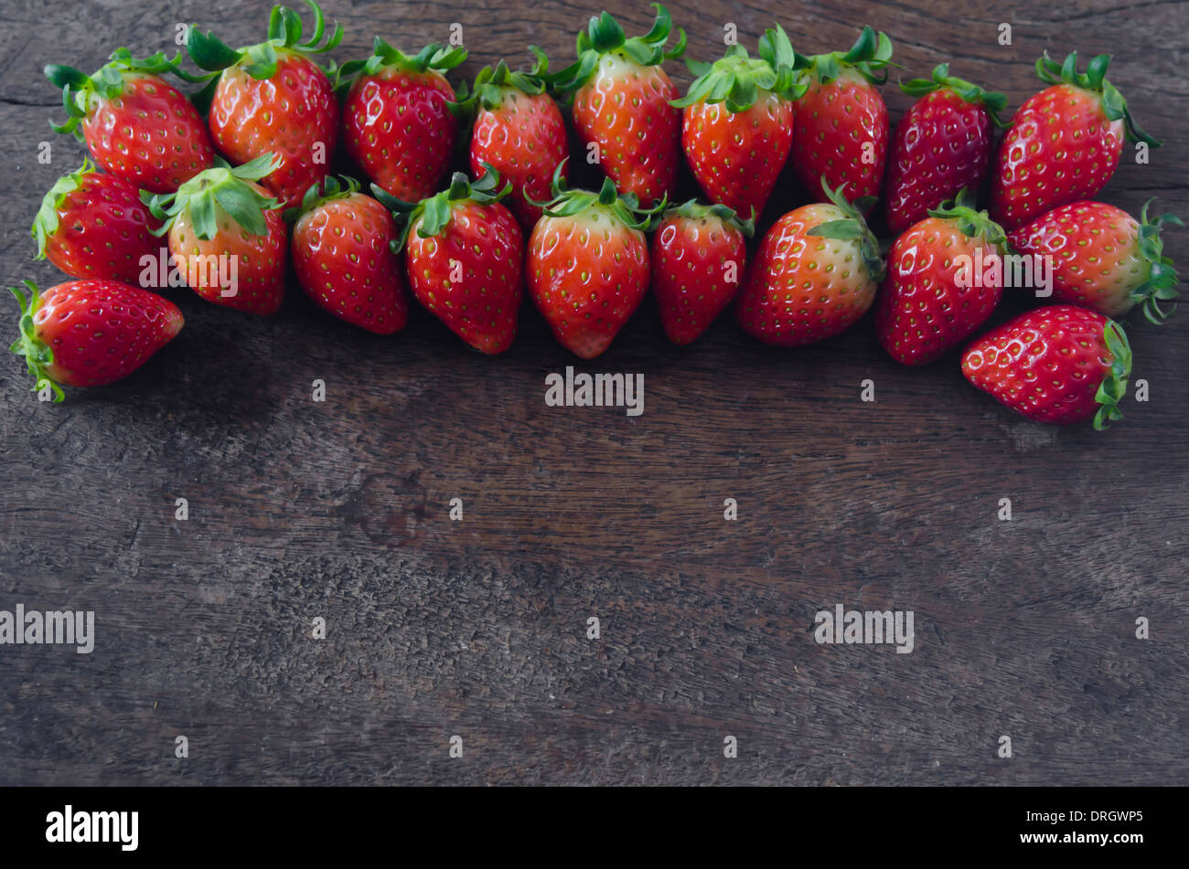 still life fresh strawberries over wooden background Stock Photo - Alamy