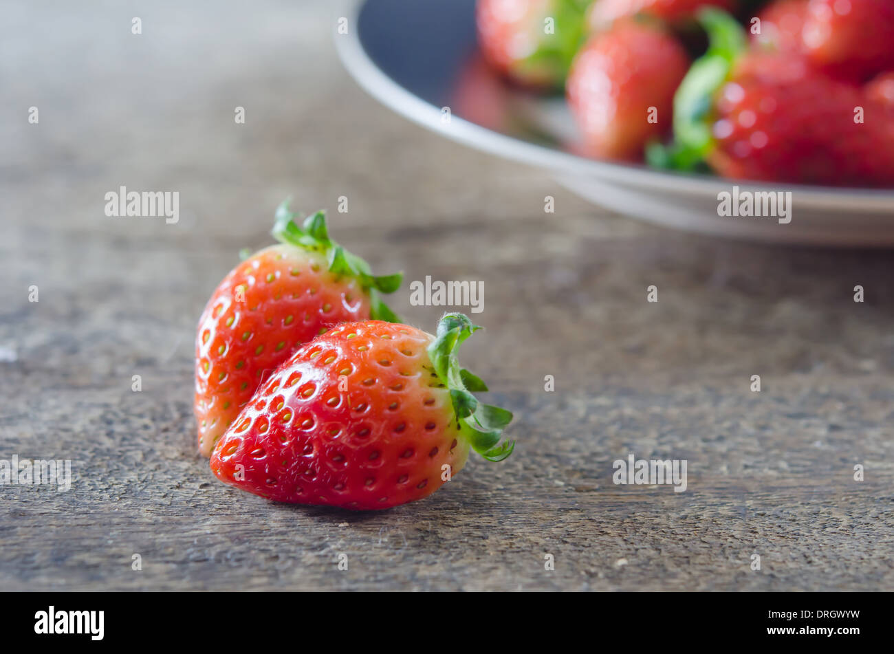 close up fresh red strawberries over wooden background Stock Photo - Alamy