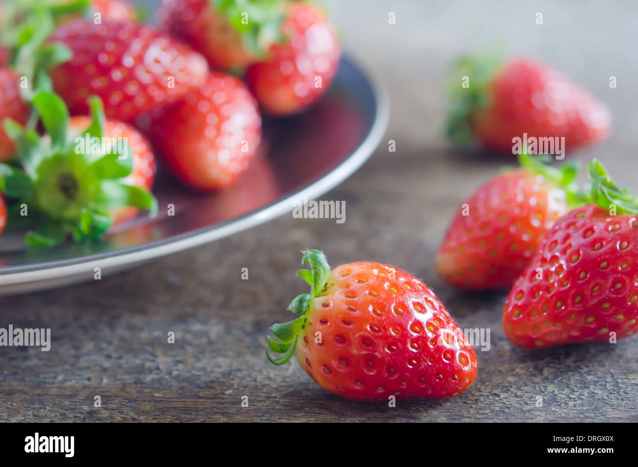 close up fresh red strawberries over wooden background Stock Photo - Alamy