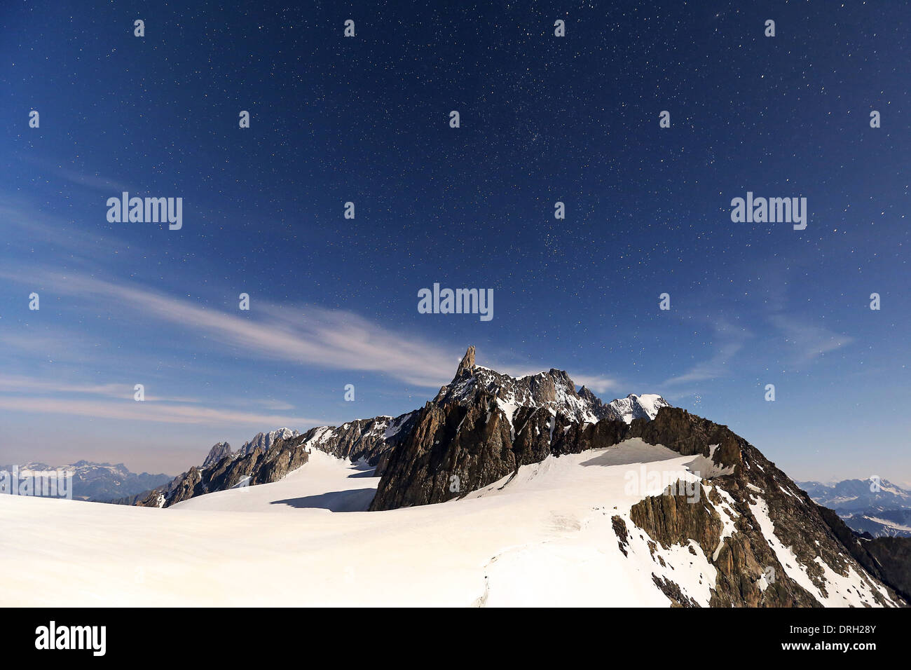 Moonlight on the Dent du Géant mountain peak.The Mont Blanc massif (Monte Bianco). Night landscape, starry sky. Alps. Stock Photo