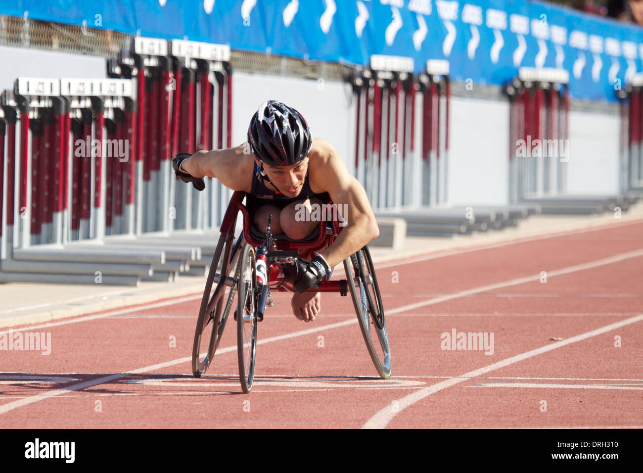 Man competing in a wheelchair race at a track and field meet in ...
