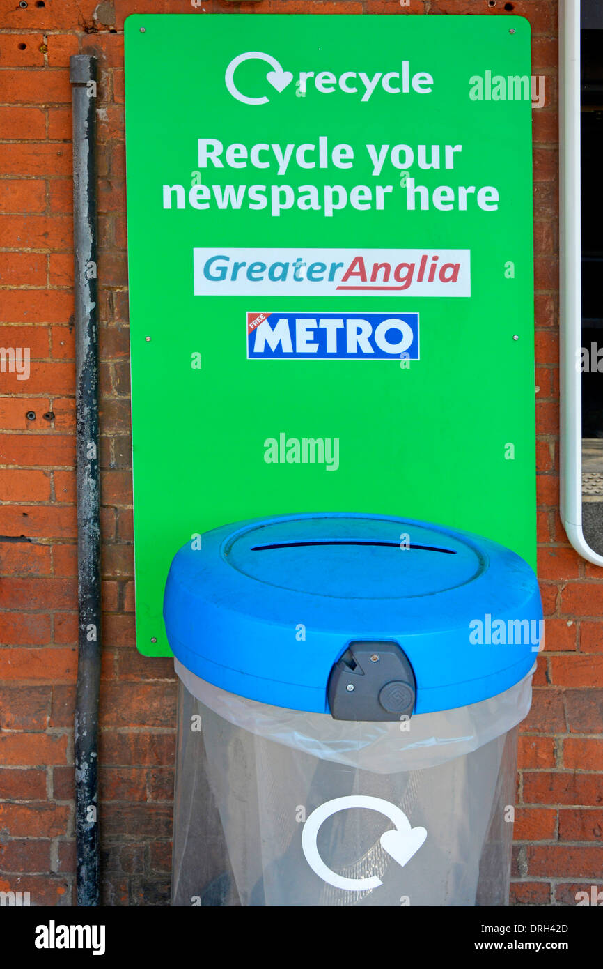 Free newspaper recycling bin on railway train station platform Stock Photo