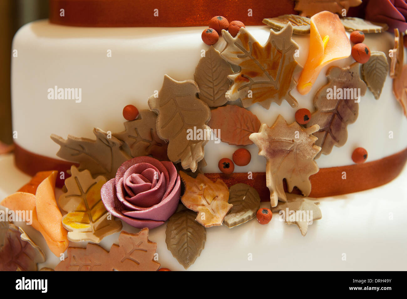 Marzipan autumn flowers on wedding cake decoration Stock Photo