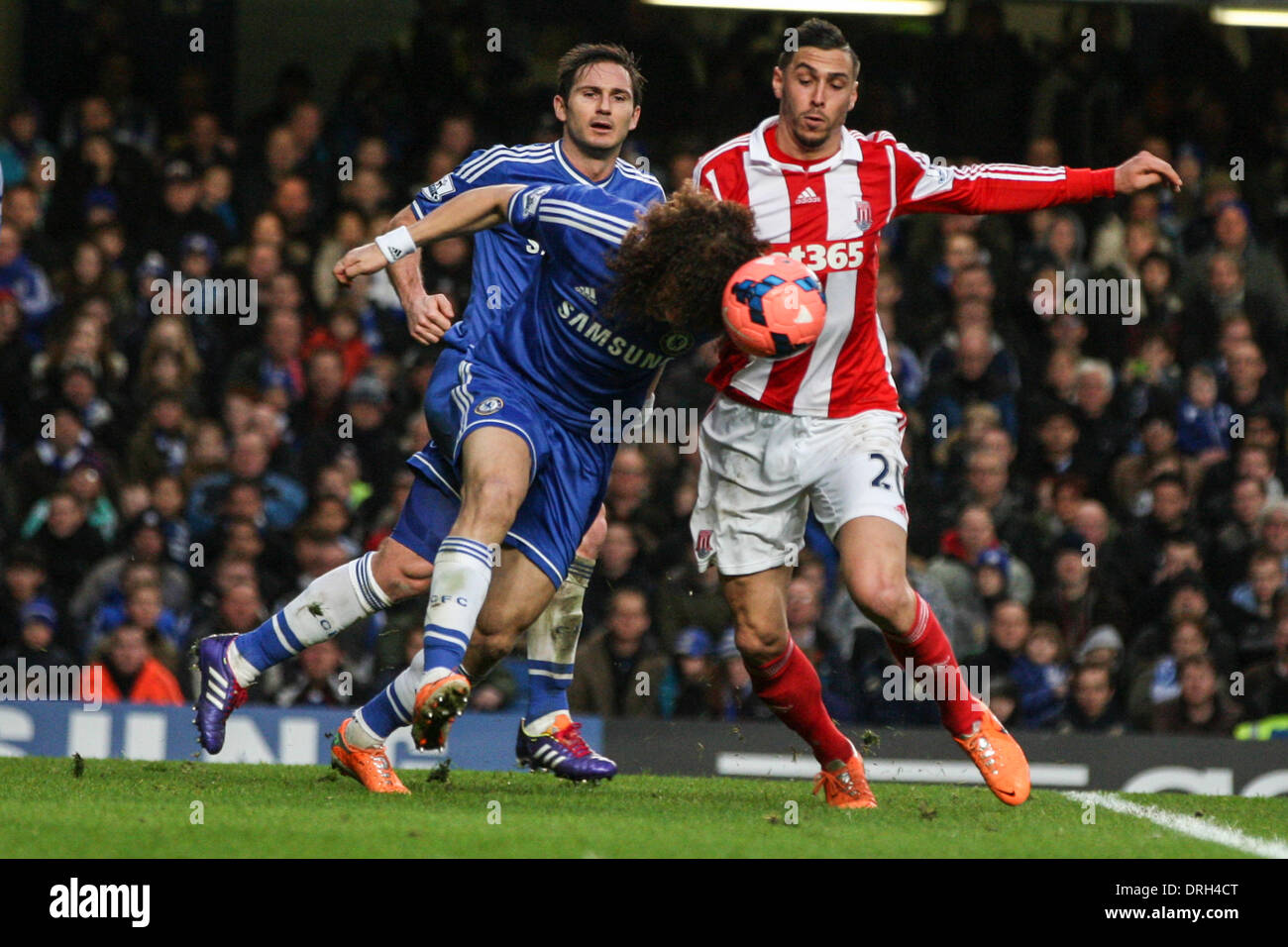 London, UK. 26th Jan, 2014. David LUIZ of Chelsea clears undre pressure from Geoff CAMERON of Stoke City during the FA Cup 4th Round match between Chelsea and Stoke City at Stamford Bridge. Final score: Chelsea 1-0 Stoke City. Credit:  Action Plus Sports/Alamy Live News Stock Photo