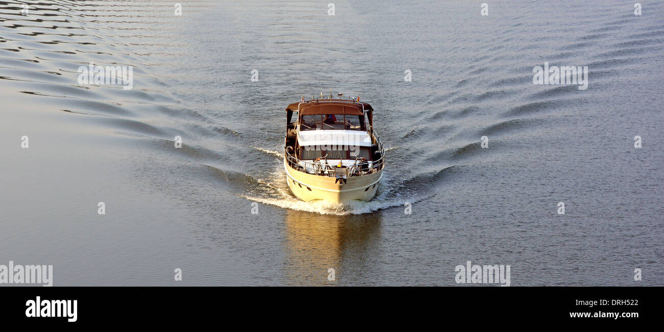 Maastricht River Meuse aerial view looking down as motorboat creates wake through still water early morning sunshine Limburg, Netherlands Europe EU Stock Photo