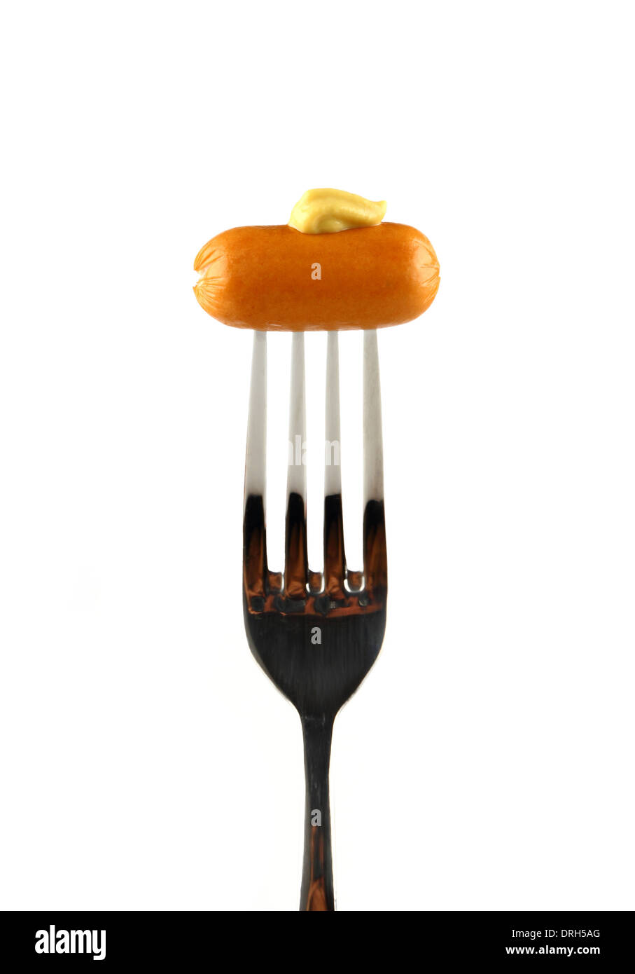 Mini cocktail sausages on fork with mustard, isolated Stock Photo