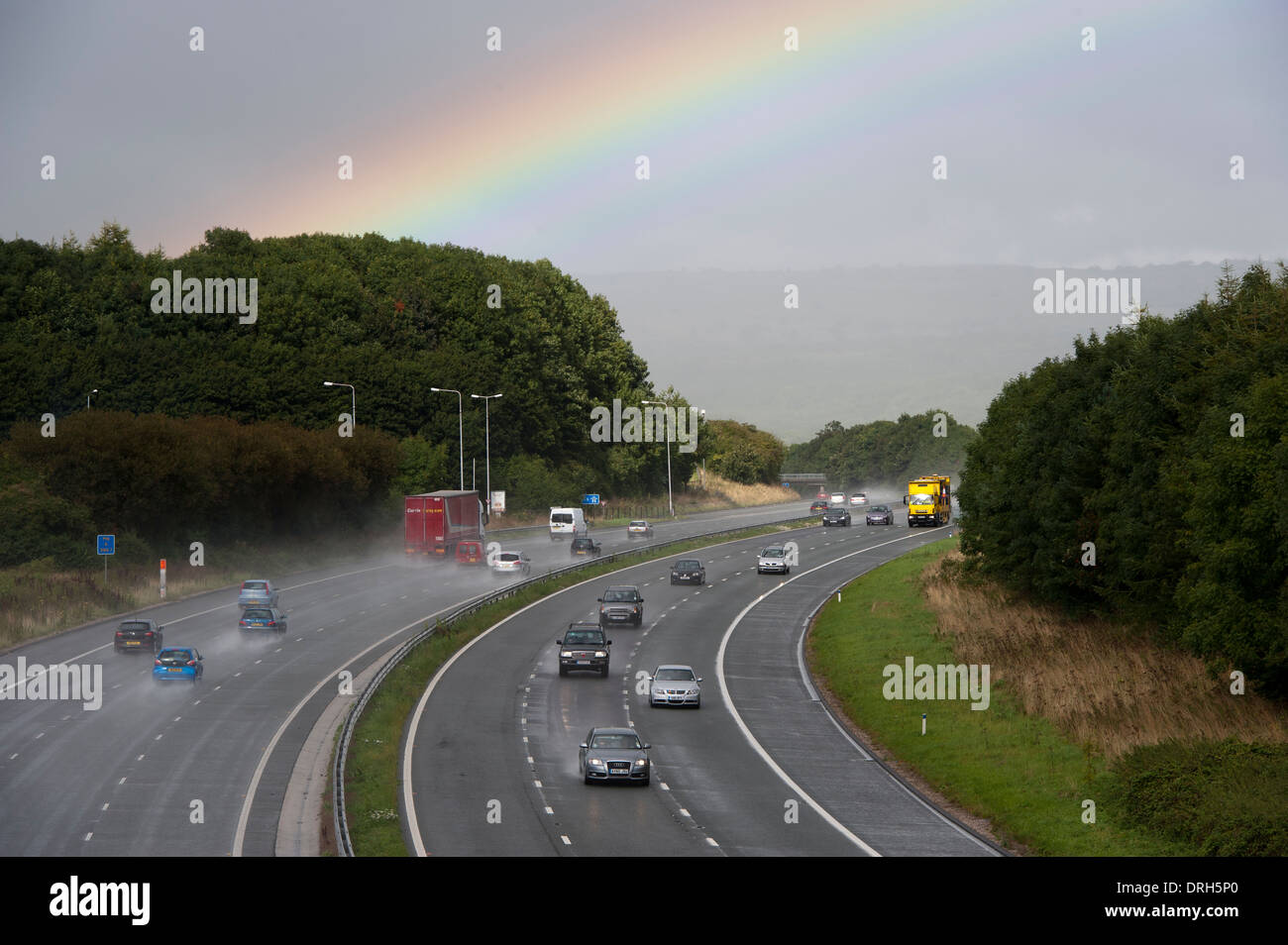 Rainbow over the M6 motorway after a sudden autumn rain shower. Cumbria. Stock Photo